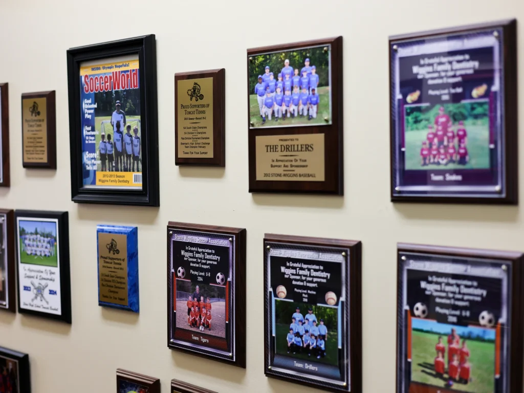 Sponsorship plaques in Wiggins Family Dentistry for local youth sports teams