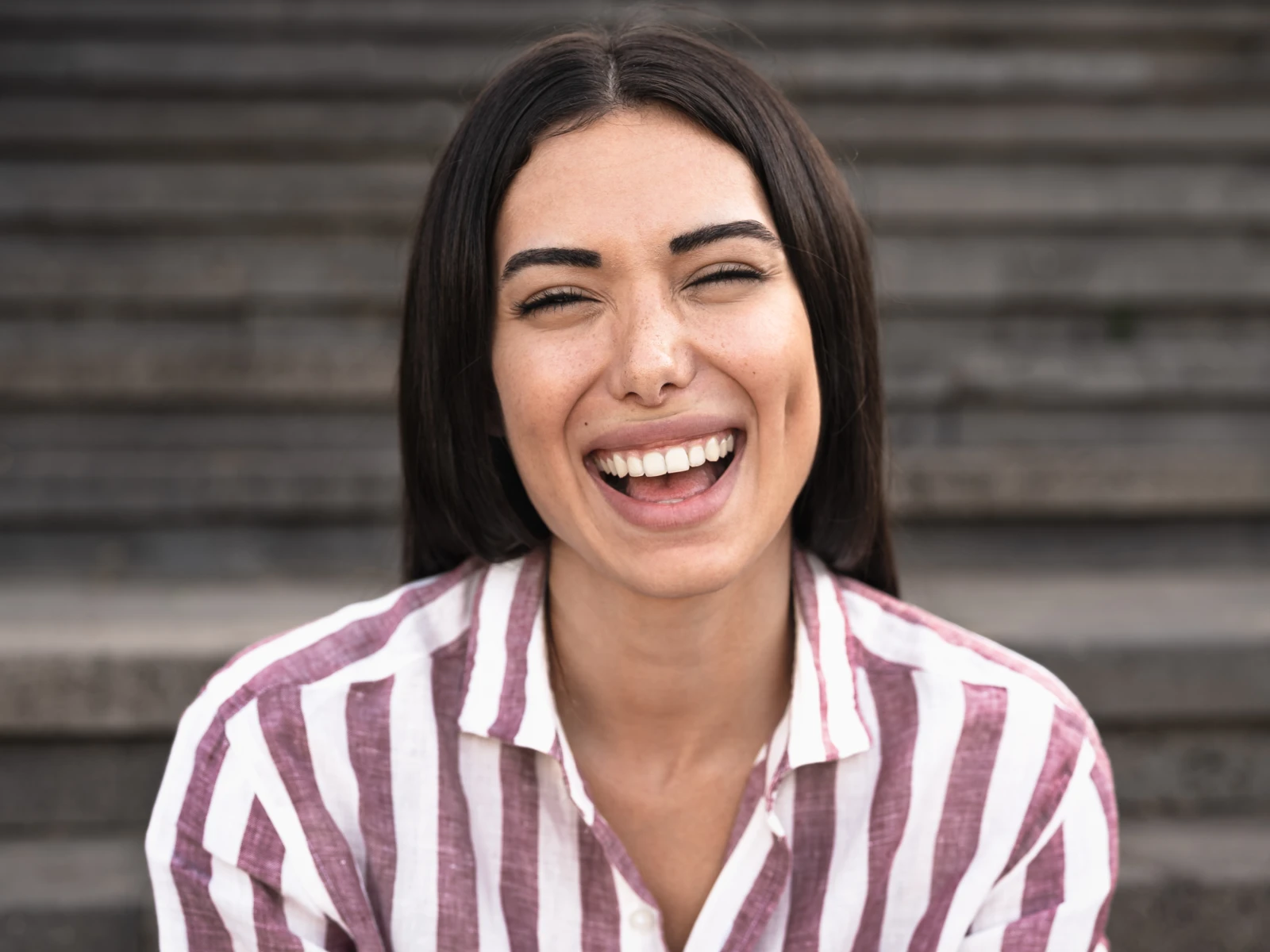 Woman smiling with perfect teeth after cosmetic dentistry in Wiggins, MS at Wiggins Family Dentistry.